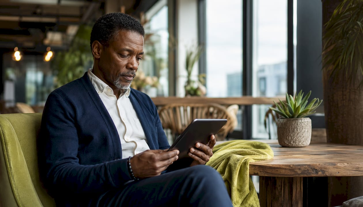 Man reviewing wellness stipend on tablet